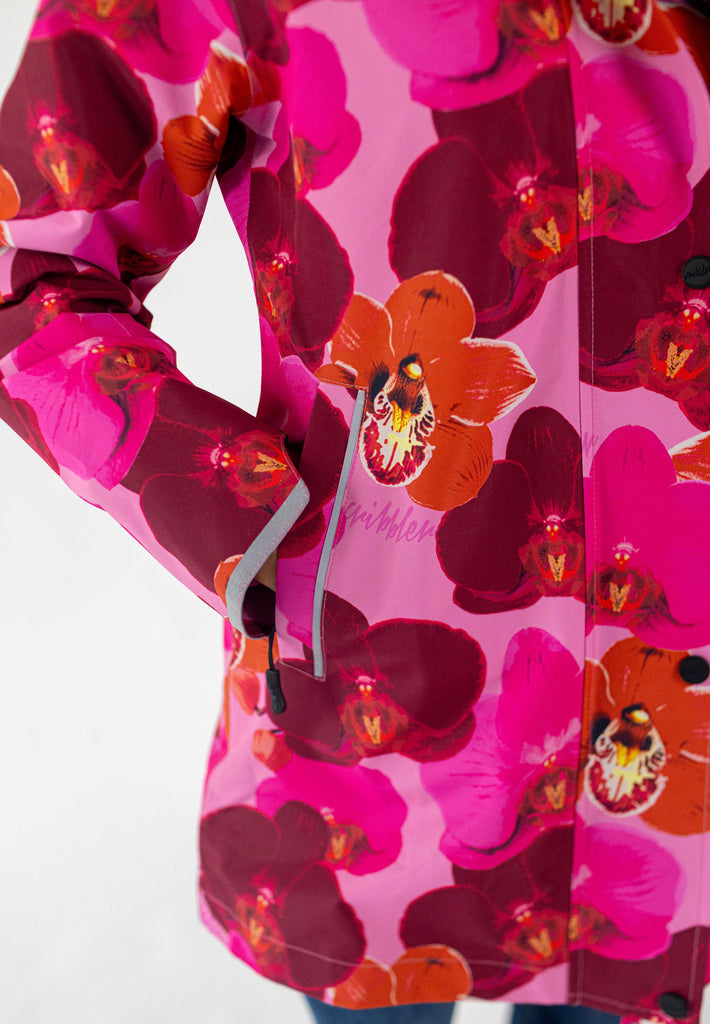 Orquidea Scribbler mesh-lined rain jacket, pink orchid floral print, raincoat, colourful printed rain wear, waterproof jacket for women, lightweight, plus size raincoat, New Zealand design, PFA free, recycled plastic fabrics.