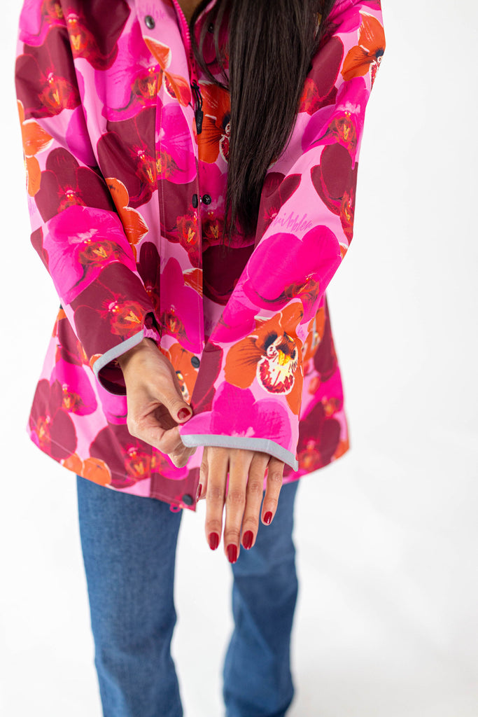 Orquidea Scribbler mesh-lined rain jacket, pink orchid floral print, raincoat, colourful printed rain wear, waterproof jacket for women, lightweight, plus size raincoat, New Zealand design, PFA free, recycled plastic fabrics.