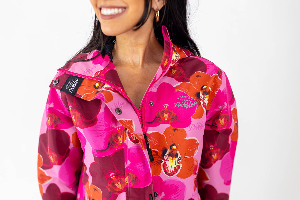 Orquidea Scribbler mesh-lined rain jacket, pink orchid floral print, raincoat, colourful printed rain wear, waterproof jacket for women, lightweight, plus size raincoat, New Zealand design, PFA free, recycled plastic fabrics.