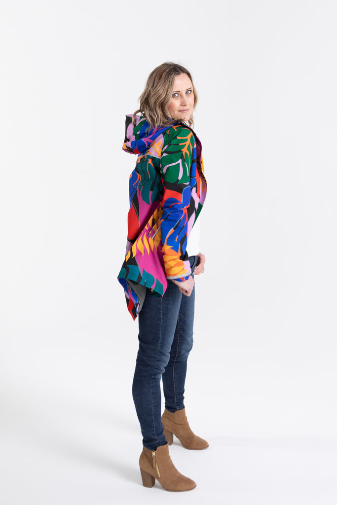 Scribbler rainwear, waterproof raincoat for women, rain jacket for ladies, outerwear, waterproof, mesh lined, lightweight, recycled plastic, sustainable fashion, winter coat, tropical Carnaval print, carnival print, mesh lined, beautiful, colourful print, breathable, packable coat, NZ, New Zealand designer, plus size, curvy, curves, mustard yellow, pink, blue, green