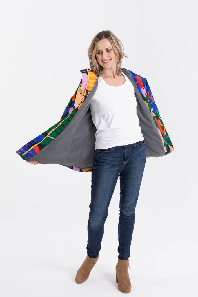 Scribbler rainwear, waterproof raincoat for women, rain jacket for ladies, outerwear, waterproof, mesh lined, lightweight, recycled plastic, sustainable fashion, winter coat, tropical Carnaval print, carnival print, mesh lined, beautiful, colourful print, breathable, packable coat, NZ, New Zealand designer, plus size, curvy, curves, mustard yellow, pink, blue, green