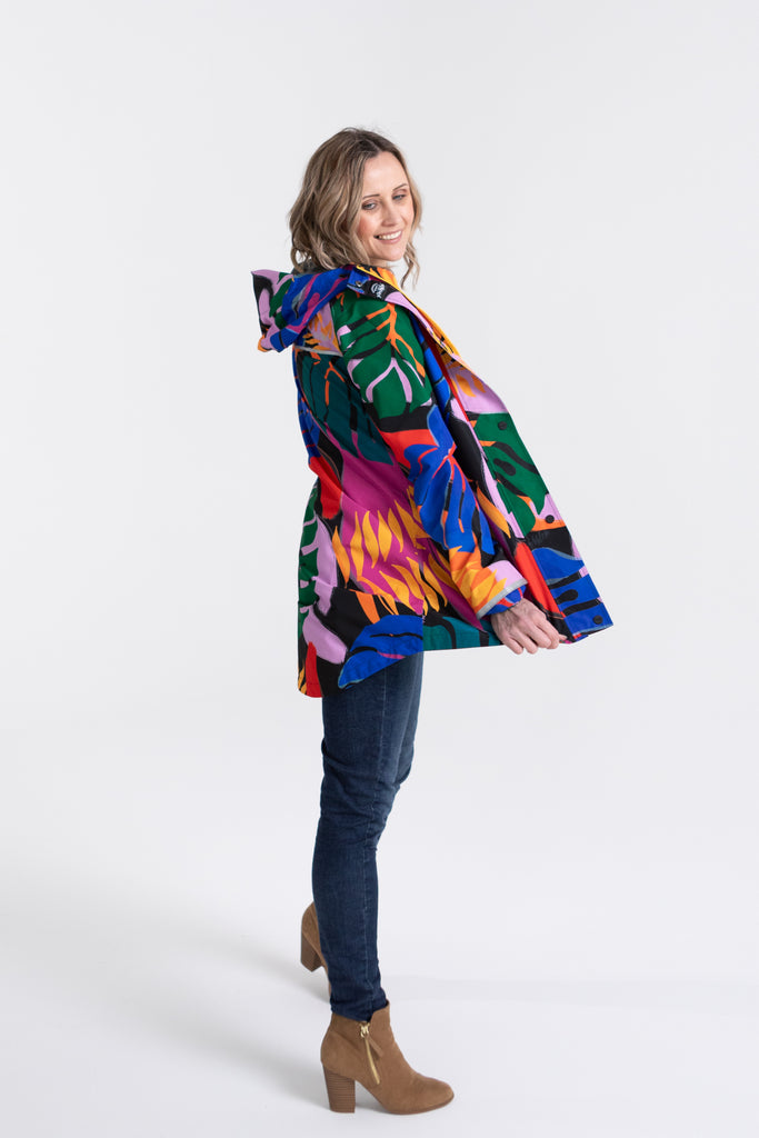 Scribbler rainwear, waterproof raincoat for women, rain jacket for ladies, outerwear, waterproof, mesh lined, lightweight, recycled plastic, sustainable fashion, winter coat, tropical Carnaval print, carnival print, mesh lined, beautiful, colourful print, breathable, packable coat, NZ, New Zealand designer, plus size, curvy, curves, mustard yellow, pink, blue, green