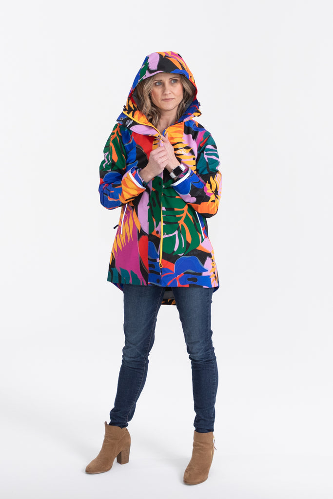 Scribbler rainwear, waterproof raincoat for women, rain jacket for ladies, outerwear, waterproof, mesh lined, lightweight, recycled plastic, sustainable fashion, winter coat, tropical Carnaval print, carnival print, mesh lined, beautiful, colourful print, breathable, packable coat, NZ, New Zealand designer, plus size, curvy, curves, mustard yellow, pink, blue, green