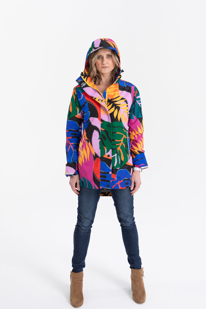 Scribbler rainwear, waterproof raincoat for women, rain jacket for ladies, outerwear, waterproof, mesh lined, lightweight, recycled plastic, sustainable fashion, winter coat, tropical Carnaval print, carnival print, mesh lined, beautiful, colourful print, breathable, packable coat, NZ, New Zealand designer, plus size, curvy, curves, mustard yellow, pink, blue, green