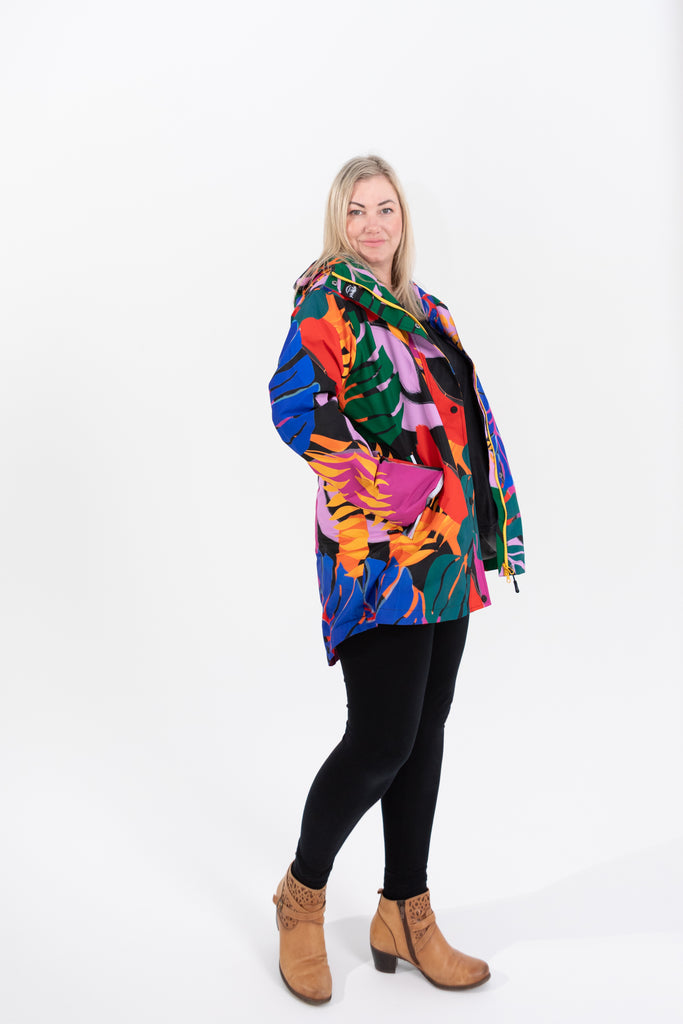 Scribbler rainwear, waterproof raincoat for women, rain jacket for ladies, outerwear, waterproof, mesh lined, lightweight, recycled plastic, sustainable fashion, winter coat, tropical Carnaval print, carnival print, mesh lined, beautiful, colourful print, breathable, packable coat, NZ, New Zealand designer, plus size, curvy, curves, mustard yellow, pink, blue, green