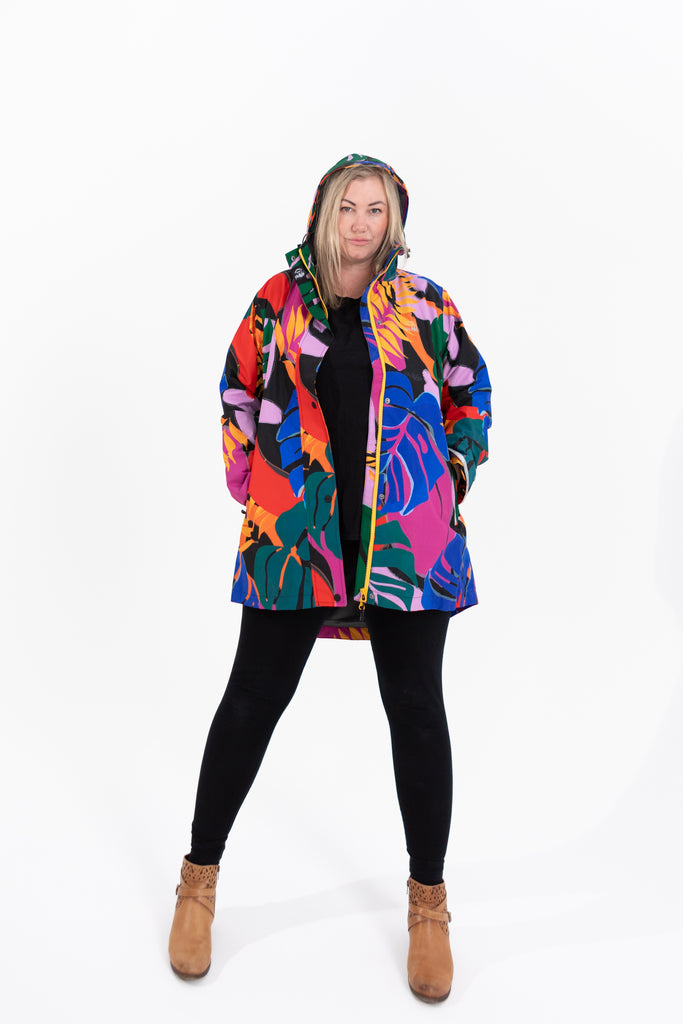 Scribbler rainwear, waterproof raincoat for women, rain jacket for ladies, outerwear, waterproof, mesh lined, lightweight, recycled plastic, sustainable fashion, winter coat, tropical Carnaval print, carnival print, mesh lined, beautiful, colourful print, breathable, packable coat, NZ, New Zealand designer, plus size, curvy, curves, mustard yellow, pink, blue, green