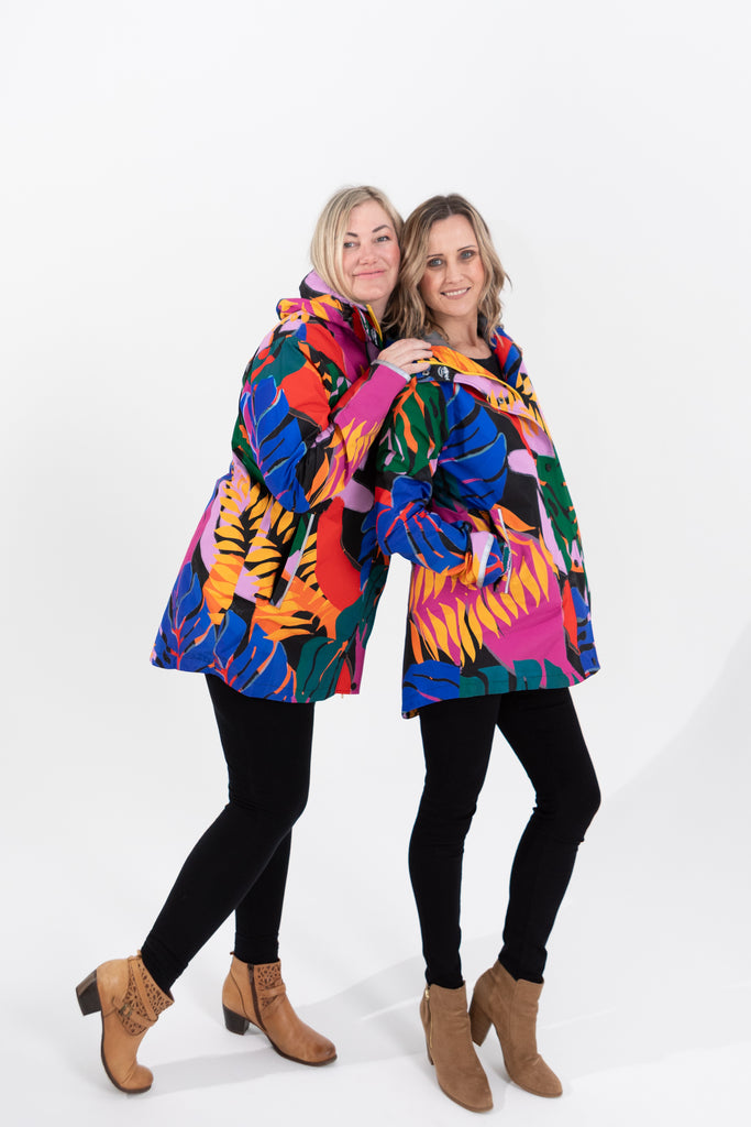 Scribbler rainwear, waterproof raincoat for women, rain jacket for ladies, outerwear, waterproof, mesh lined, lightweight, recycled plastic, sustainable fashion, winter coat, tropical Carnaval print, carnival print, mesh lined, beautiful, colourful print, breathable, packable coat, NZ, New Zealand designer, plus size, curvy, curves, mustard yellow, pink, blue, green