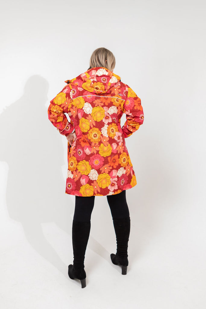Solar, Scribbler floral rain jacket, yellow rain jacket, pink, orange, white flowers, raincoat, waterproof, plus sizes, New Zealand design, recycled plastic, sustainable fashion, rain gear, outdoor wear for women, rain jacket