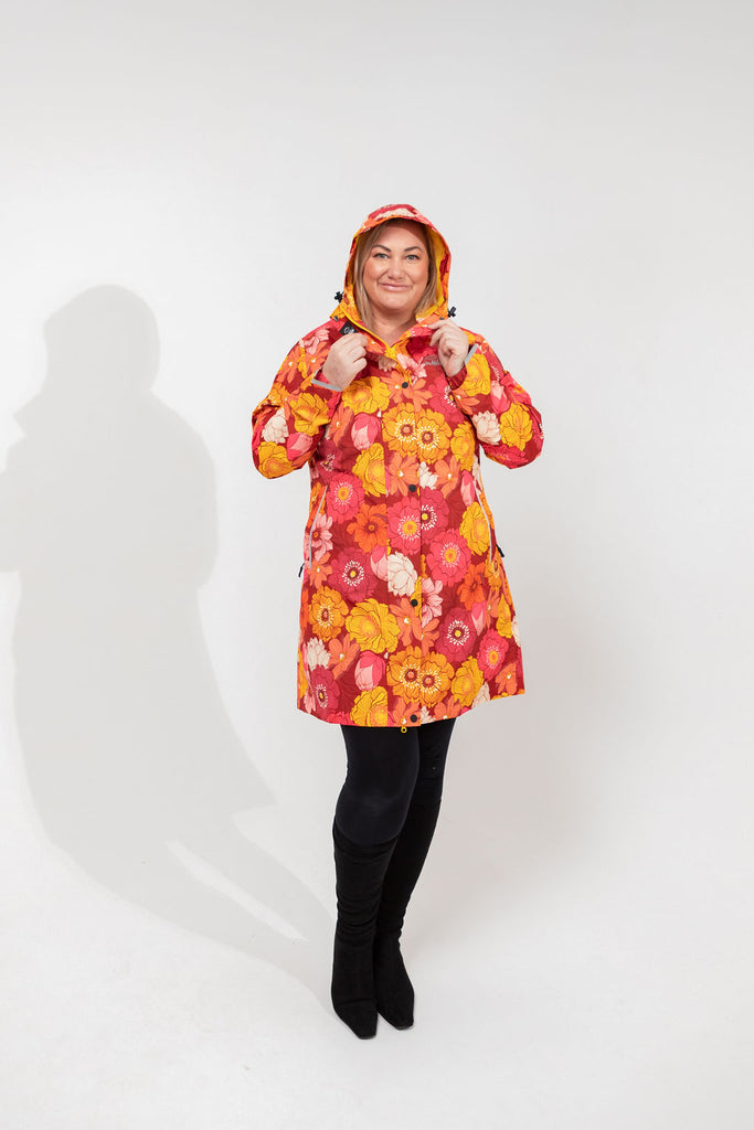Solar, Scribbler floral rain jacket, yellow rain jacket, pink, orange, white flowers, raincoat, waterproof, plus sizes, New Zealand design, recycled plastic, sustainable fashion, rain gear, outdoor wear for women, rain jacket