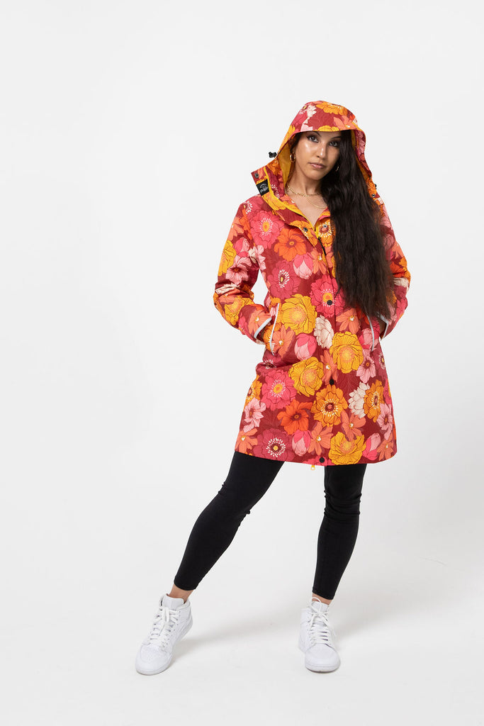Solar, Scribbler floral rain jacket, yellow rain jacket, pink, orange, white flowers, raincoat, waterproof, plus sizes, New Zealand design, recycled plastic, sustainable fashion, rain gear, outdoor wear for women, rain jacket