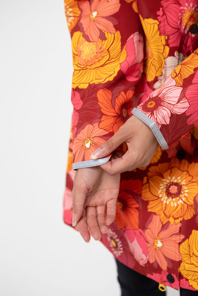 Solar, Scribbler floral rain jacket, yellow rain jacket, pink, orange, white flowers, raincoat, waterproof, plus sizes, New Zealand design, recycled plastic, sustainable fashion, rain gear, outdoor wear for women, rain jacket