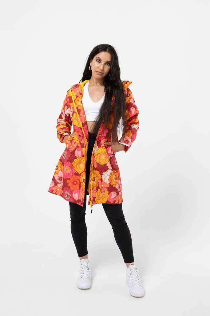 Solar, Scribbler floral rain jacket, yellow rain jacket, pink, orange, white flowers, raincoat, waterproof, plus sizes, New Zealand design, recycled plastic, sustainable fashion, rain gear, outdoor wear for women, rain jacket