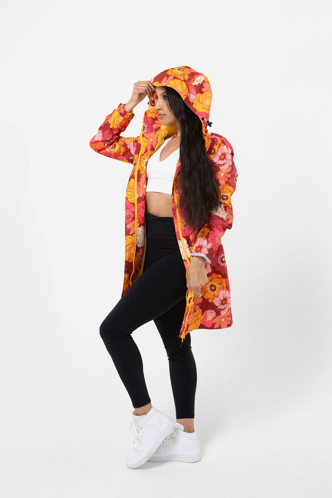 Solar, Scribbler floral rain jacket, yellow rain jacket, pink, orange, white flowers, raincoat, waterproof, plus sizes, New Zealand design, recycled plastic, sustainable fashion, rain gear, outdoor wear for women, rain jacket