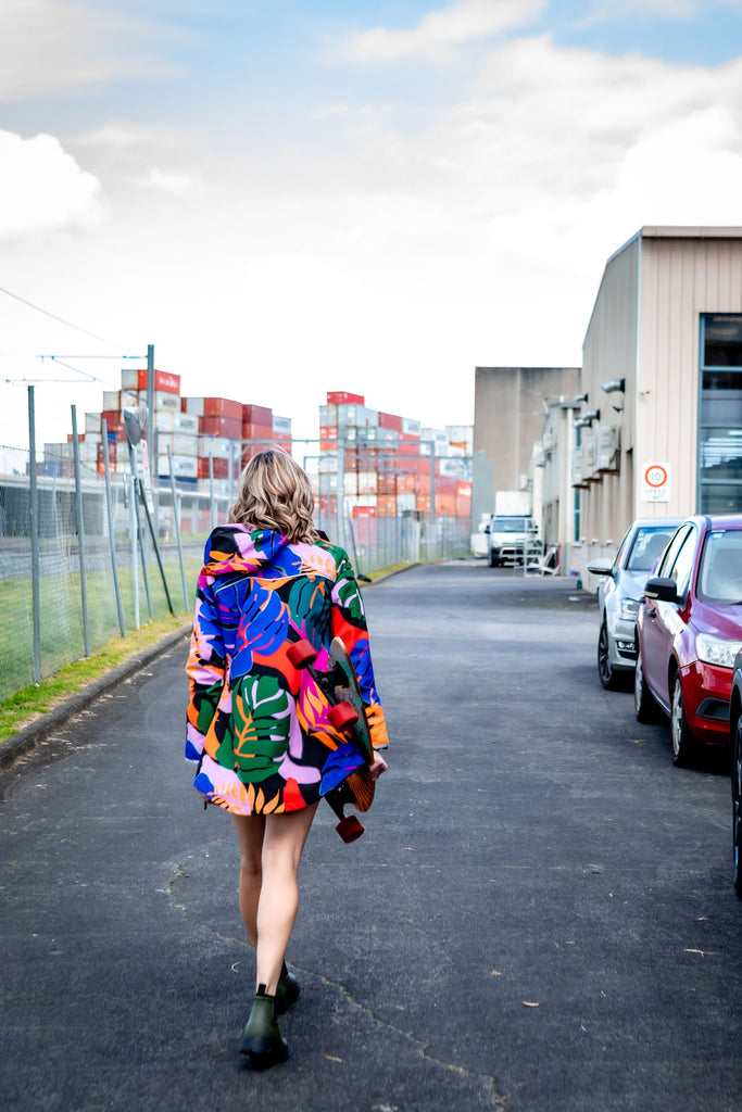 Scribbler rainwear, waterproof raincoat for women, rain jacket for ladies, outerwear, waterproof, mesh lined, lightweight, recycled plastic, sustainable fashion, winter coat, tropical Carnaval print, carnival print, mesh lined, beautiful, colourful print, breathable, packable coat, NZ, New Zealand designer, plus size, curvy, curves, mustard yellow, pink, blue, green