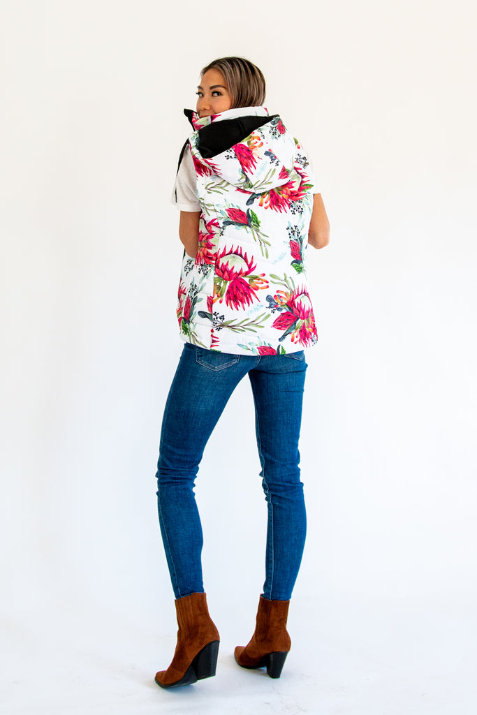 Scribbler protea vest, African protea print, White puffer vest, waterproof gilet, recycled fabric, recycled puffer, conscious fashion, plus size vest, floral vest, removable hood, botanical print, quilted vest, plus size vest, NZ, New Zealand, Australia, USA