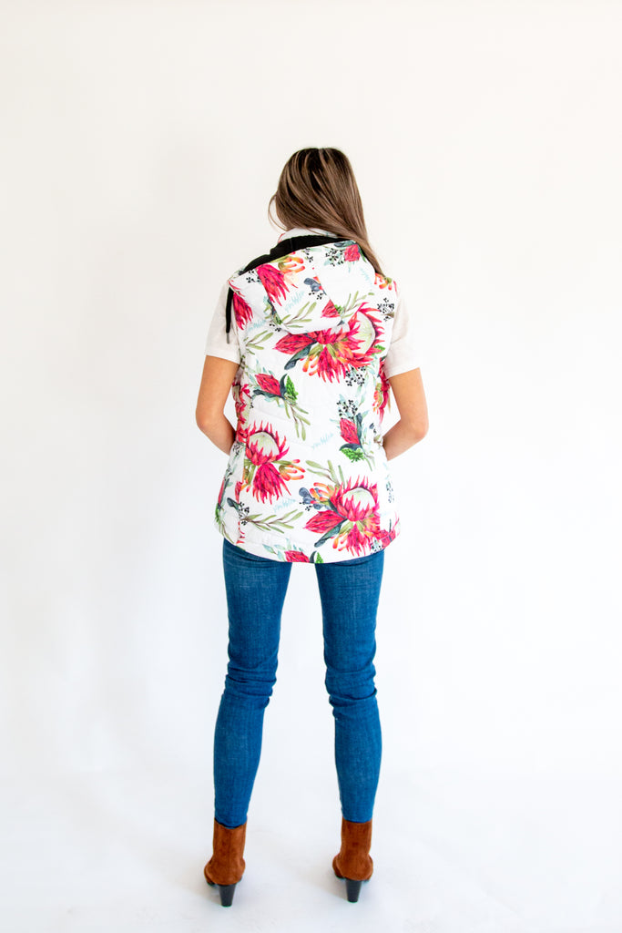 Scribbler protea vest, African protea print, White puffer vest, waterproof gilet, recycled fabric, recycled puffer, conscious fashion, plus size vest, floral vest, removable hood, botanical print, printed vest, colourful vest, quilted vest, plus size vest, NZ, New Zealand, Australia, USA