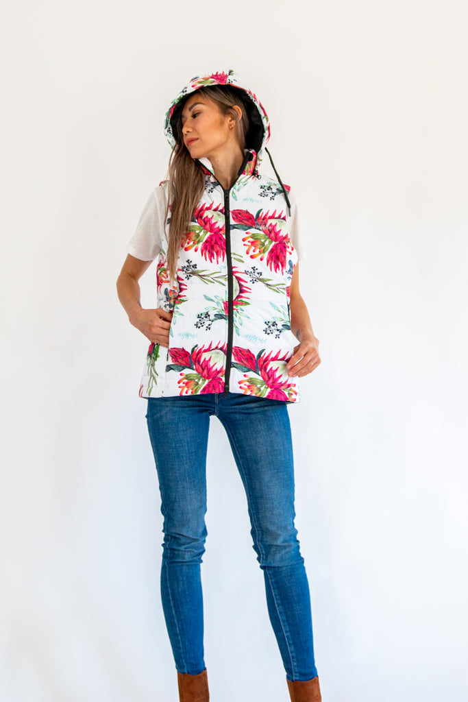Scribbler protea vest, African protea print, White puffer vest, waterproof gilet, recycled fabric, recycled puffer, conscious fashion, plus size vest, floral vest, removable hood, botanical print, printed vest, colourful vest, quilted vest, plus size vest, NZ, New Zealand, Australia, USA
