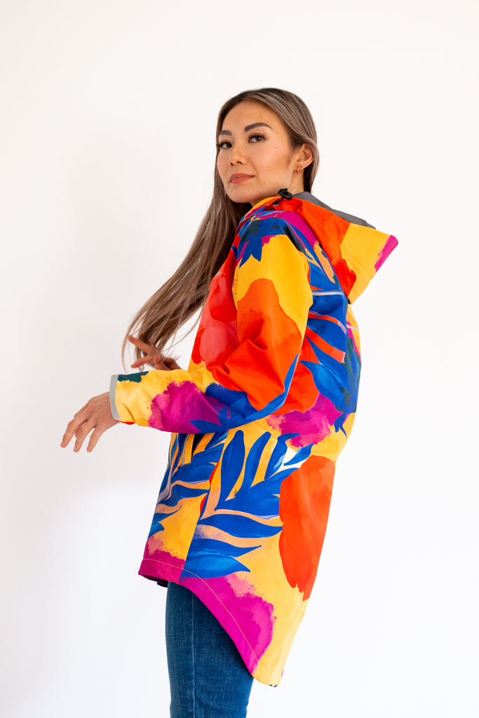 Scribbler rainwear, waterproof raincoat for women, rain jacket for ladies, outerwear, waterproof, mesh lined, lightweight, recycled plastic, sustainable fashion, winter coat, tropical Caribe print, mesh lined, beautiful, colourful print, breathable, packable coat, NZ, New Zealand designer, plus size, curvy, curves, mustard yellow, pink, blue