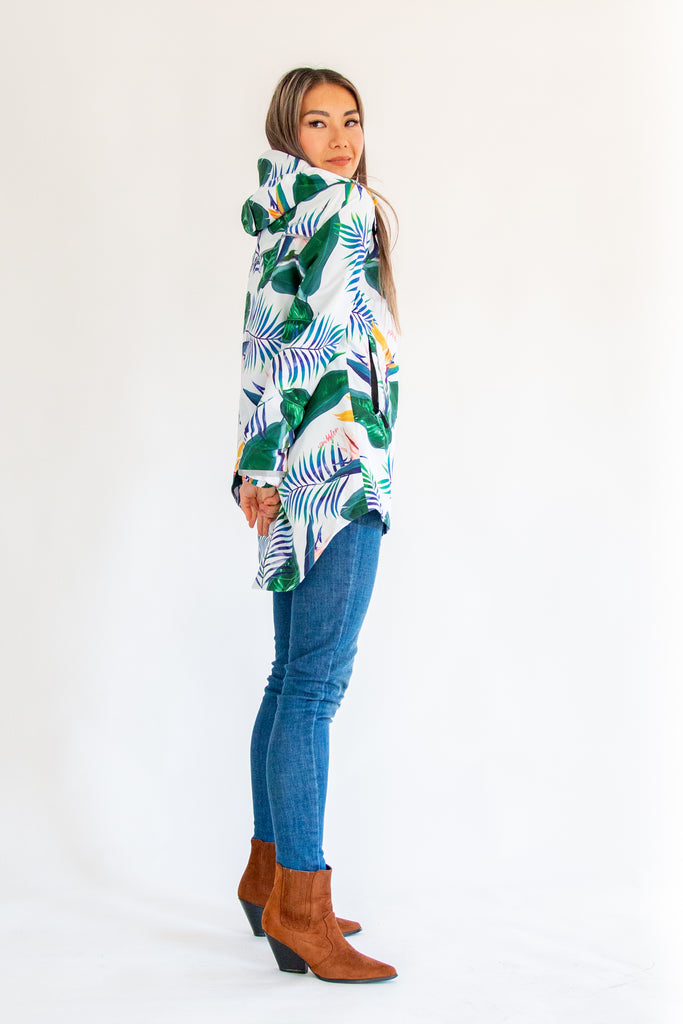 Scribbler rainwear, waterproof raincoat for women, rain jacket for ladies, outerwear, waterproof, mesh lined, lightweight, recycled plastic, sustainable fashion, winter coat, tropical Tropic print, mesh lined, beautiful, colourful print, breathable, packable coat, NZ, New Zealand designer, plus size, curvy, curves, white, green leaves, strelitzia, colourful rain jacket