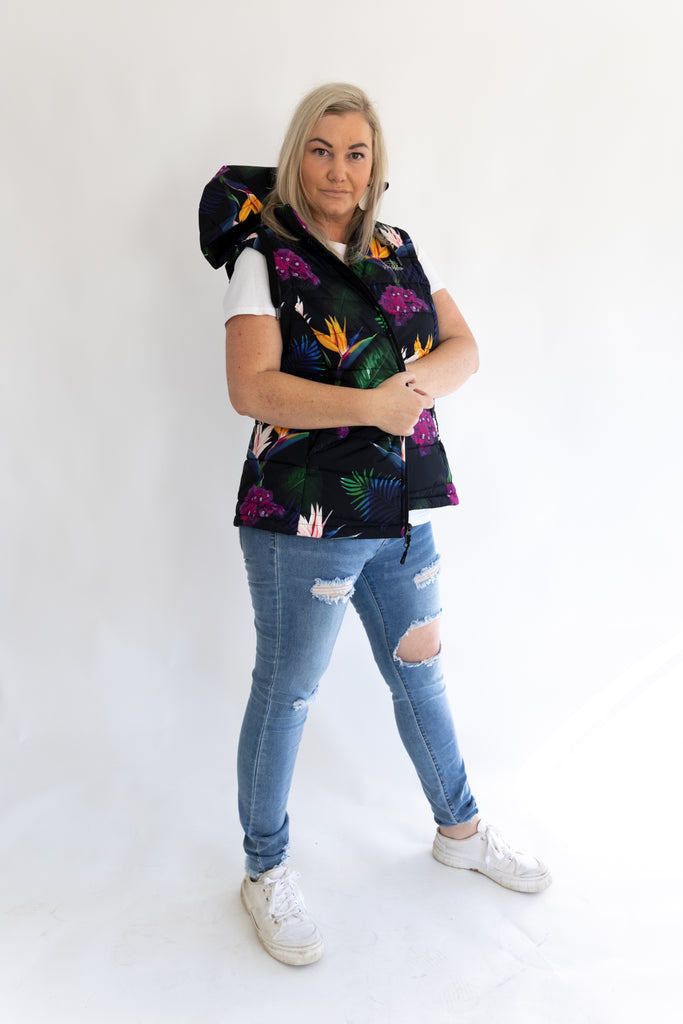 Scribbler paradiso vest, tropical print, black colourful puffer vest, waterproof gilet, recycled fabric, recycled puffer, conscious fashion, plus size vest, floral vest, removable hood, tropical print, printed vest, colourful vest, black puffer vest, quilted vest, plus size vest, NZ, New Zealand, Australia, USA