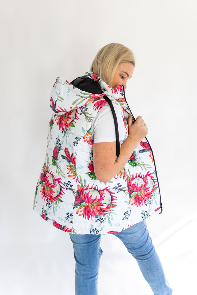 Scribbler protea vest, African protea print, White puffer vest, waterproof gilet, recycled fabric, recycled puffer, conscious fashion, plus size vest, floral vest, removable hood, botanical print, quilted vest, plus size vest, NZ, New Zealand, Australia, USA